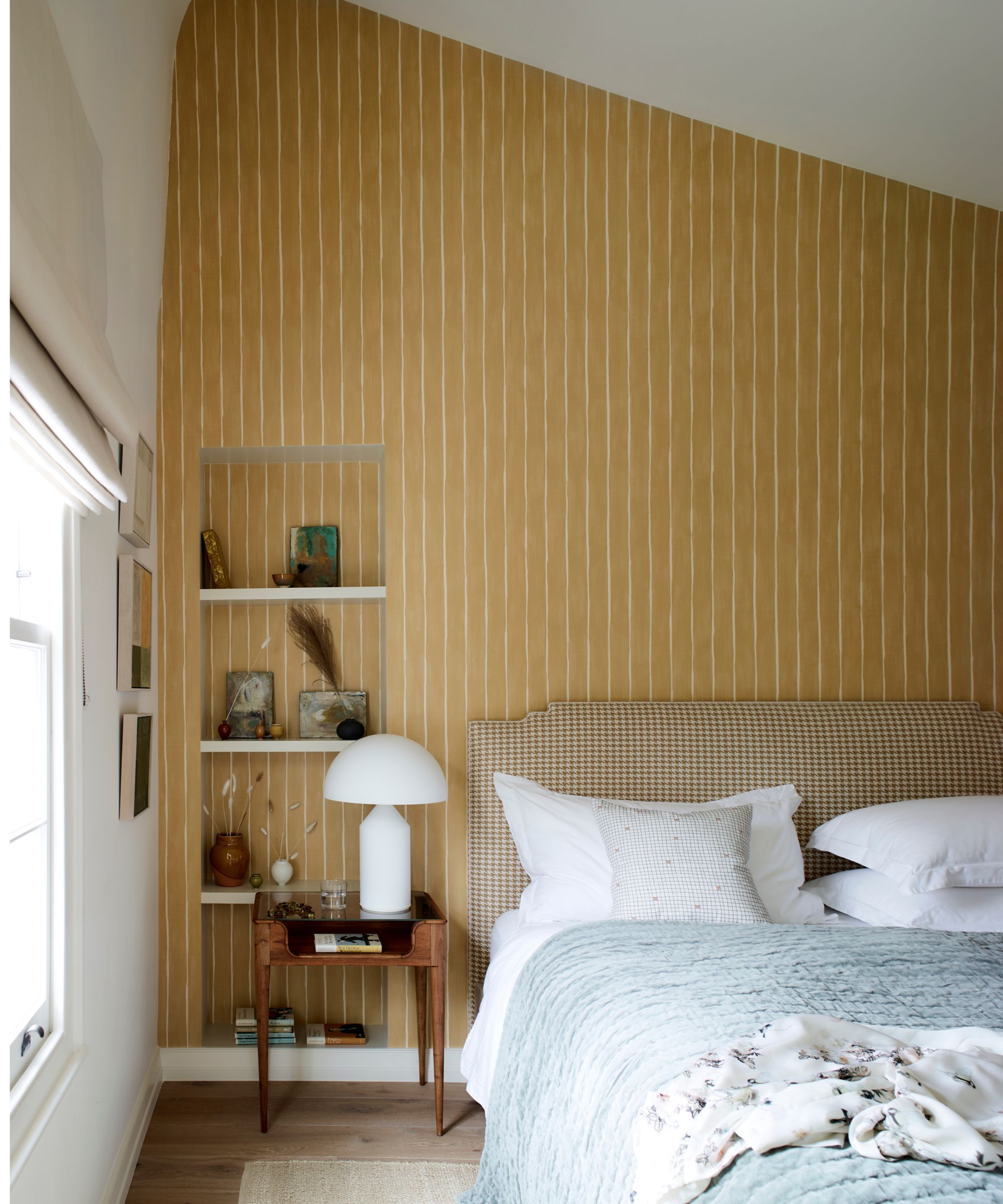 Bedroom with subtle striped yellow wallpaper