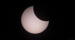 K.J. Mulder snapped a series of partial-solar-eclipse photos Sept. 13 from his home in South Africa, using a 3.5-inch Skywatcher refractor telescope equipped with a Baader solar filter. Hazy clouds occasionally blocked his view.