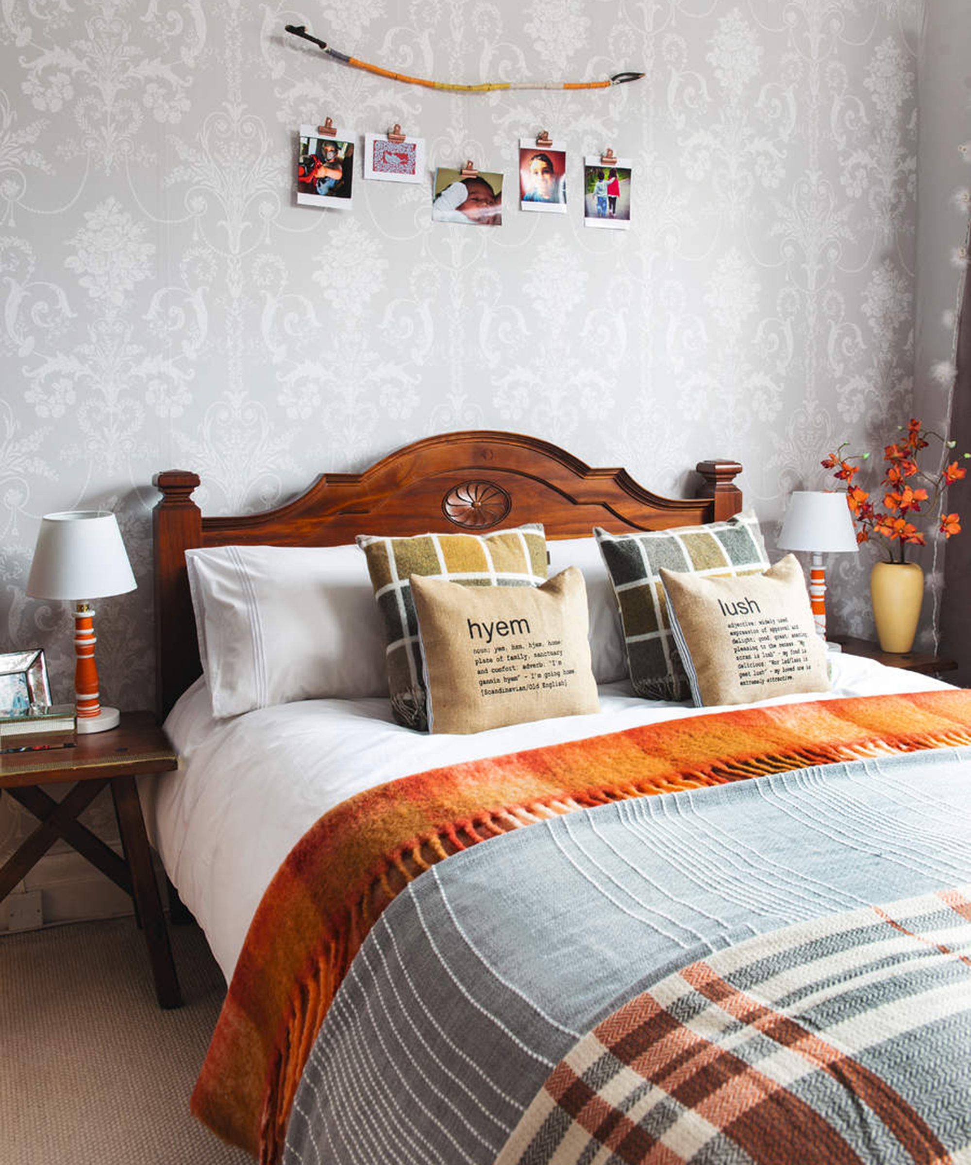 A master bedroom with rustic shades of orange and warm wood