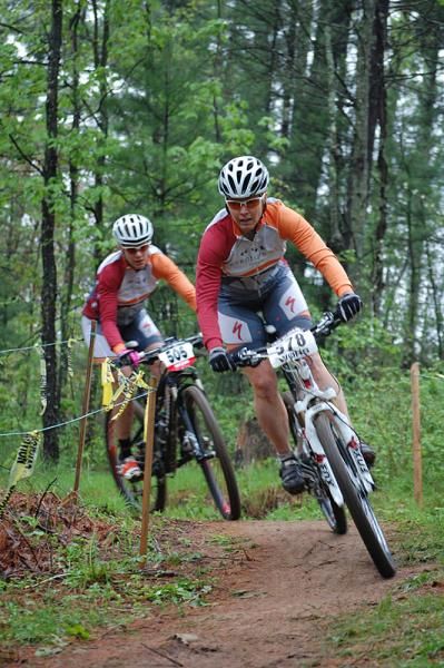 Diana McFadden (Adventure 212 / Specialized) leads teammate Sarah Agena-Wright over the crest of the first climb.