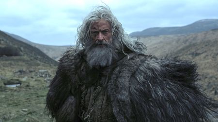Hugh Jackman with a beard staring ahead in The Death of Robin Hood