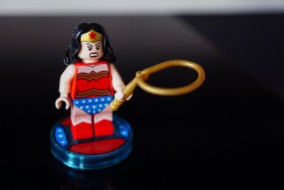 Lego Wonder Woman grimaces while holding golden rope.