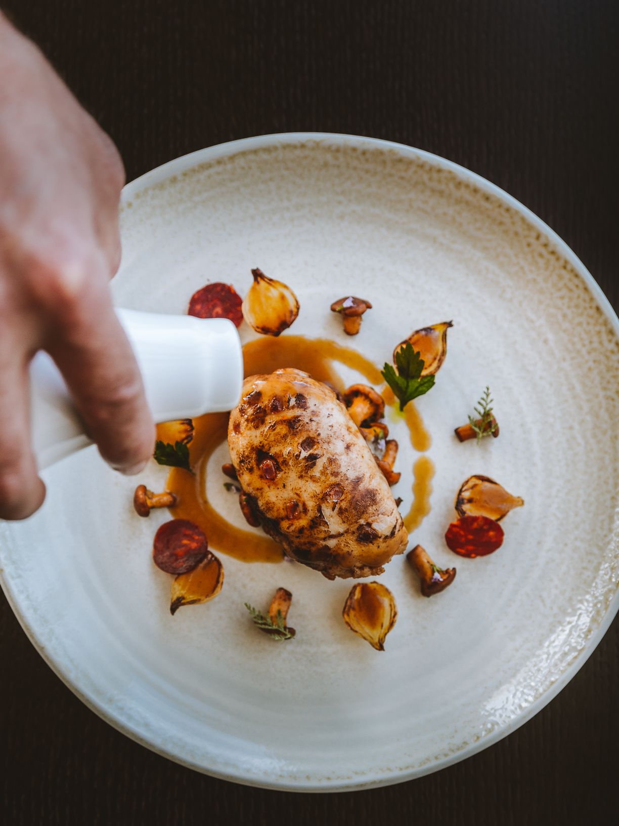 A minimalist hotel with cream tones throughout boasts floor-to-ceiling windows, historical accents, and a naturally lit atmosphere.