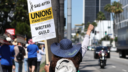 image of a striking worker sag-aftra wga strikes