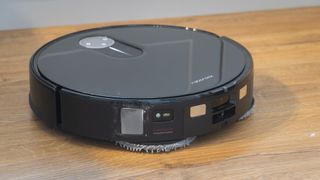 Roborock Qrevo Slim robot vacuum cleaning a hard floor