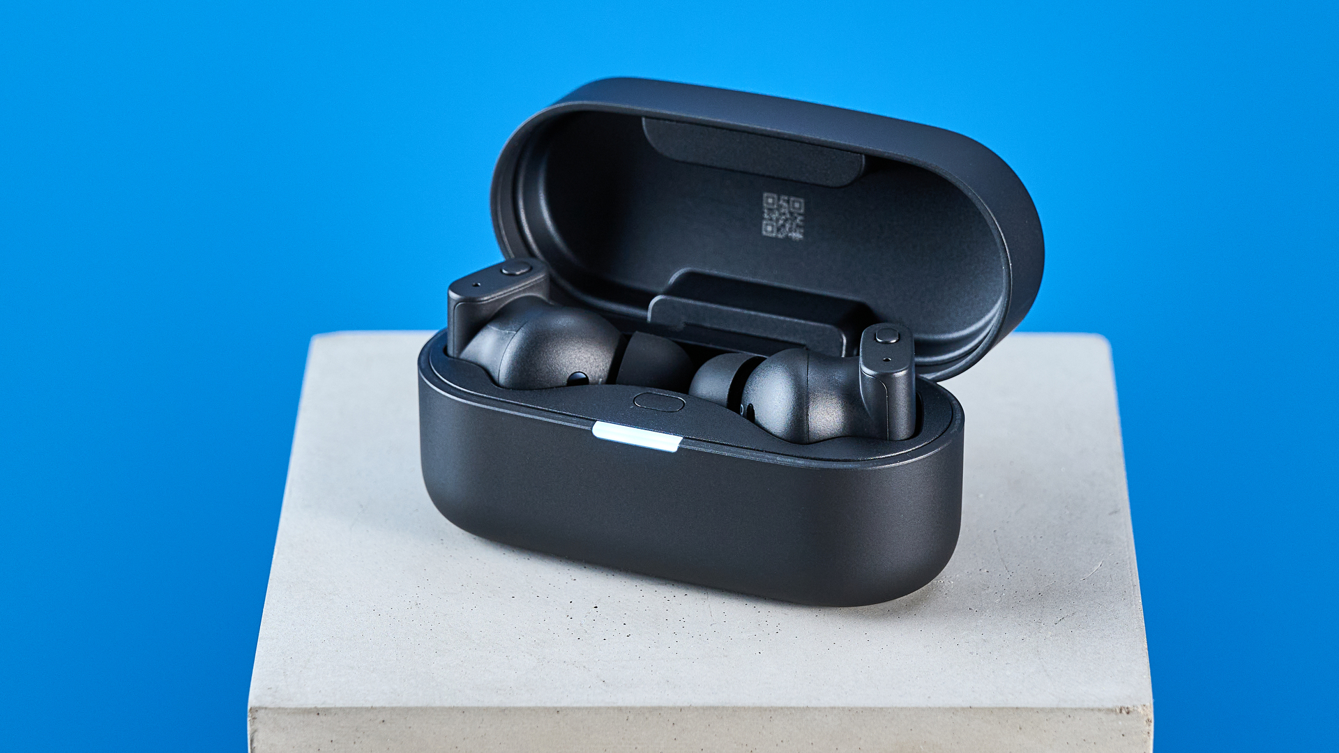 A pair of black Status Pro X wireless earbuds