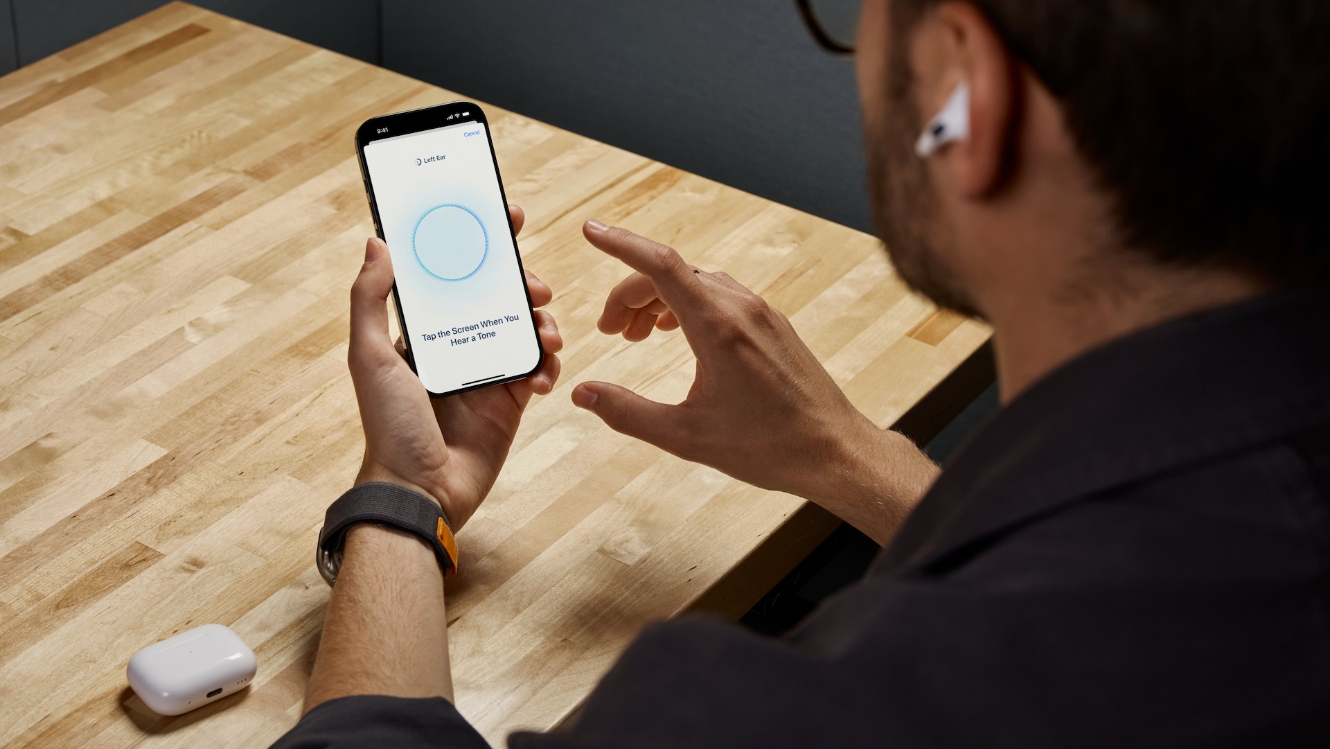 A man trying out the Apple Health hearing aid test