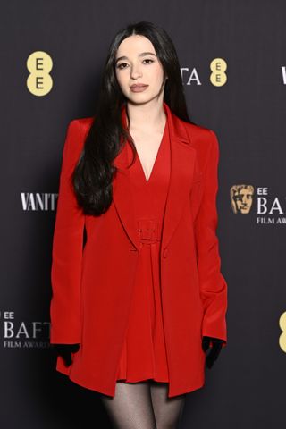 Mikey Madison wears a tomato red blazer at the 2025 BAFTA Rising Star Party.