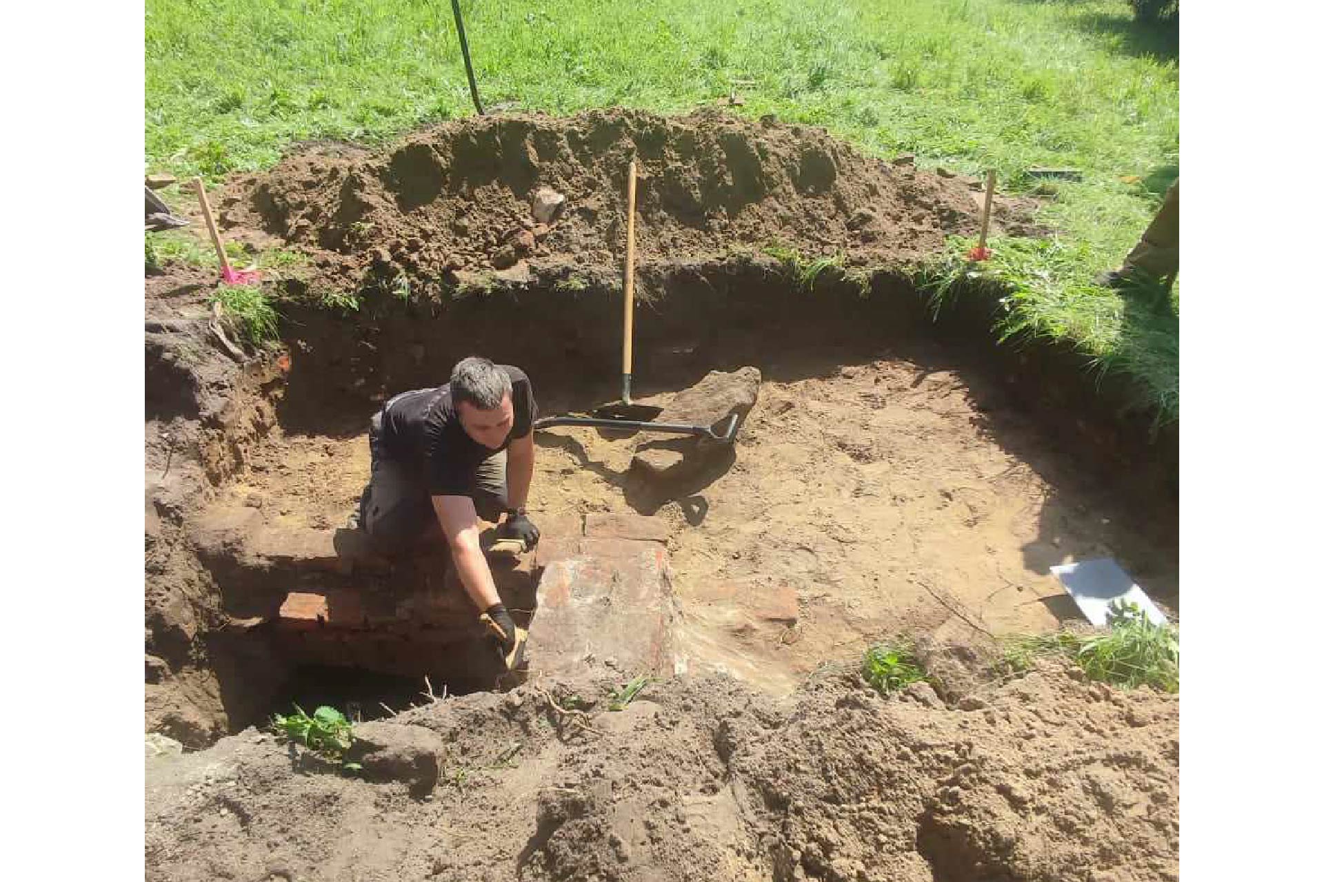 A man excavates from a pit