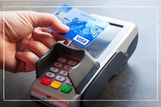 person making a contactless payment with a credit card