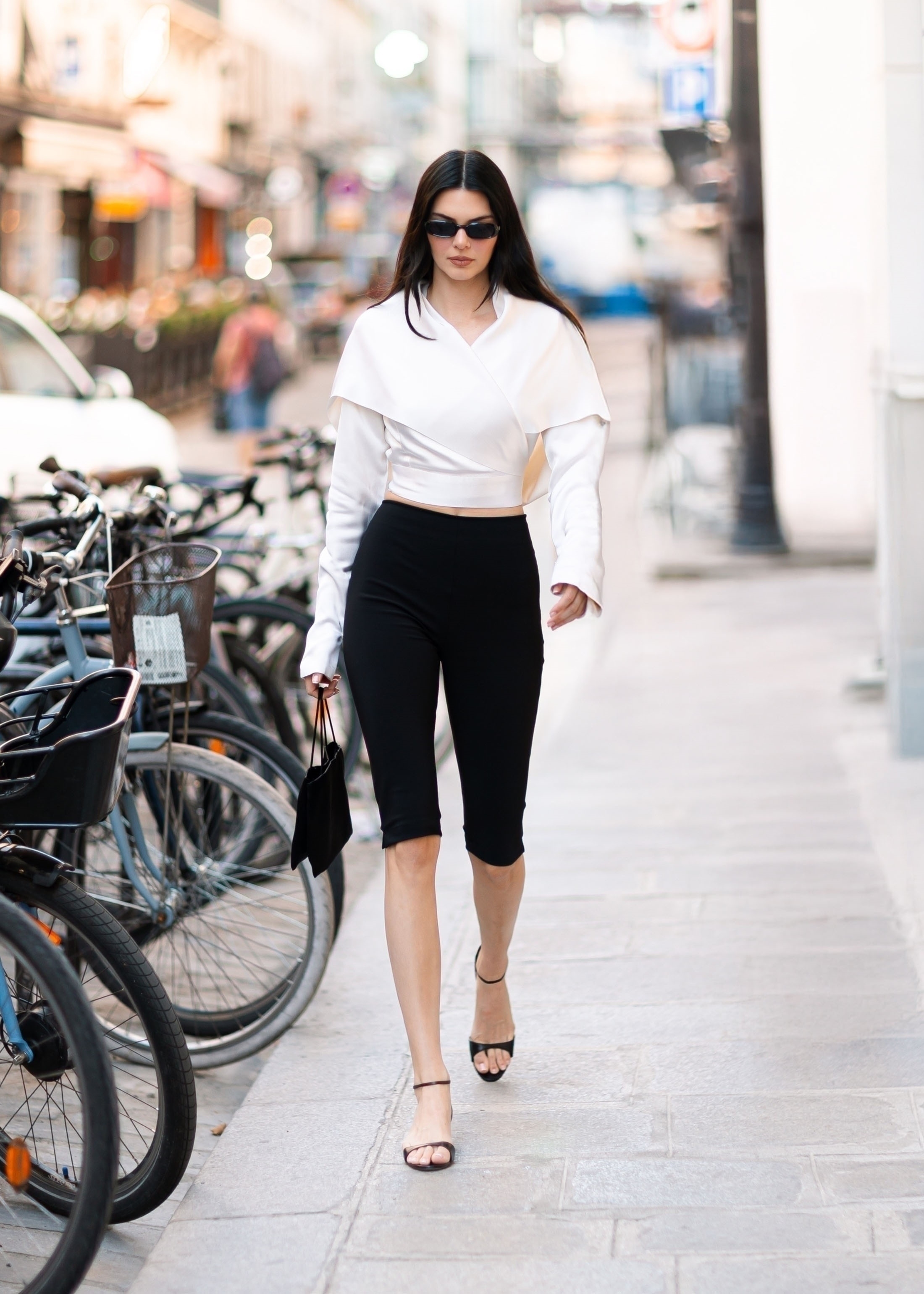 Kendall Jenner styled capri pants, a white top, and a The Row bag in Paris.