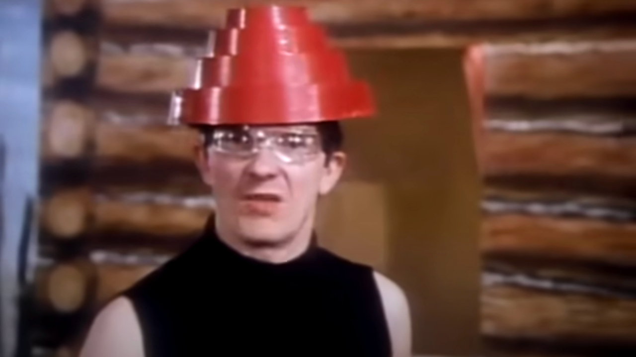 Mark Mothersbaugh wearing his traditional Devo get up in the music video for Whip It.
