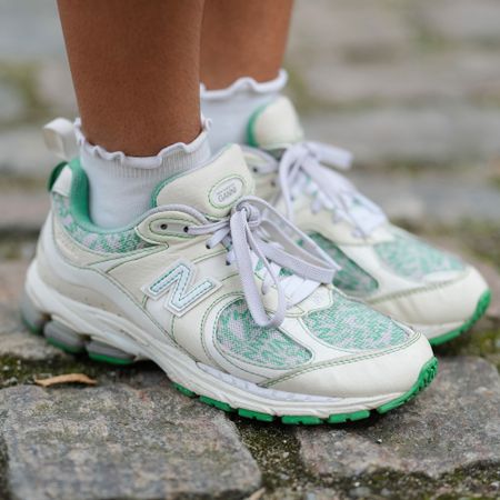 a woman wears ruffled socks with New Balance sneakers