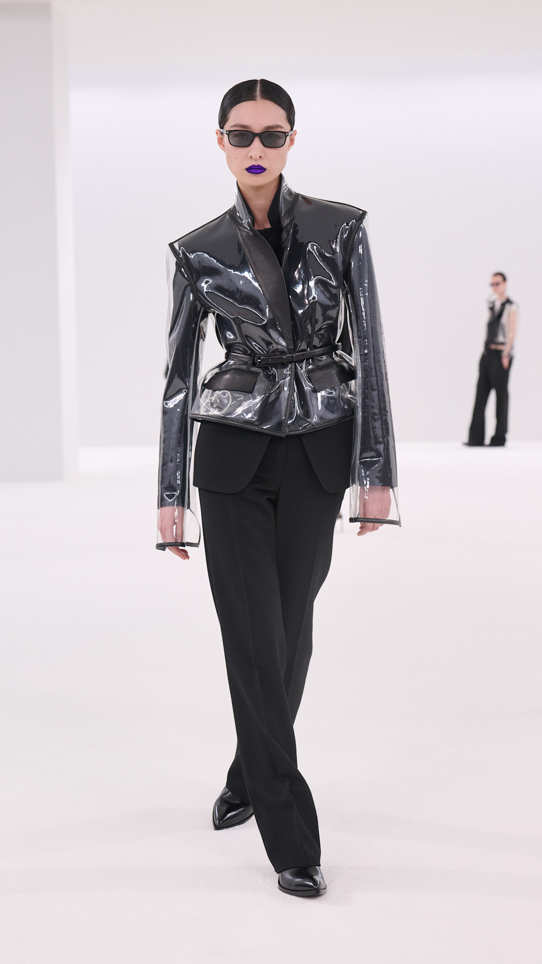 a Tom Ford model wearing a PVC cropped jacket and black pants
