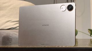 The Honor Pad V9 on a bronze table.