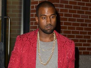 Kanye West out for dinner with Kim Kardashian in a grey tshirt and red blazer