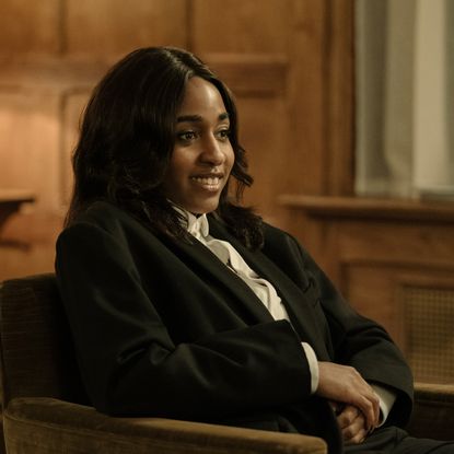 ayo edebiri as maggie wearing a blazer sitting in a chair at a party in after the hunt