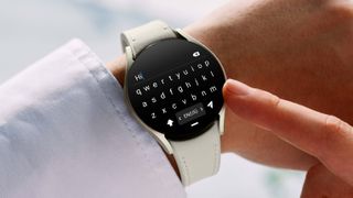 Samsung Galaxy Watch 6 worn on wrist with keyboard display screen