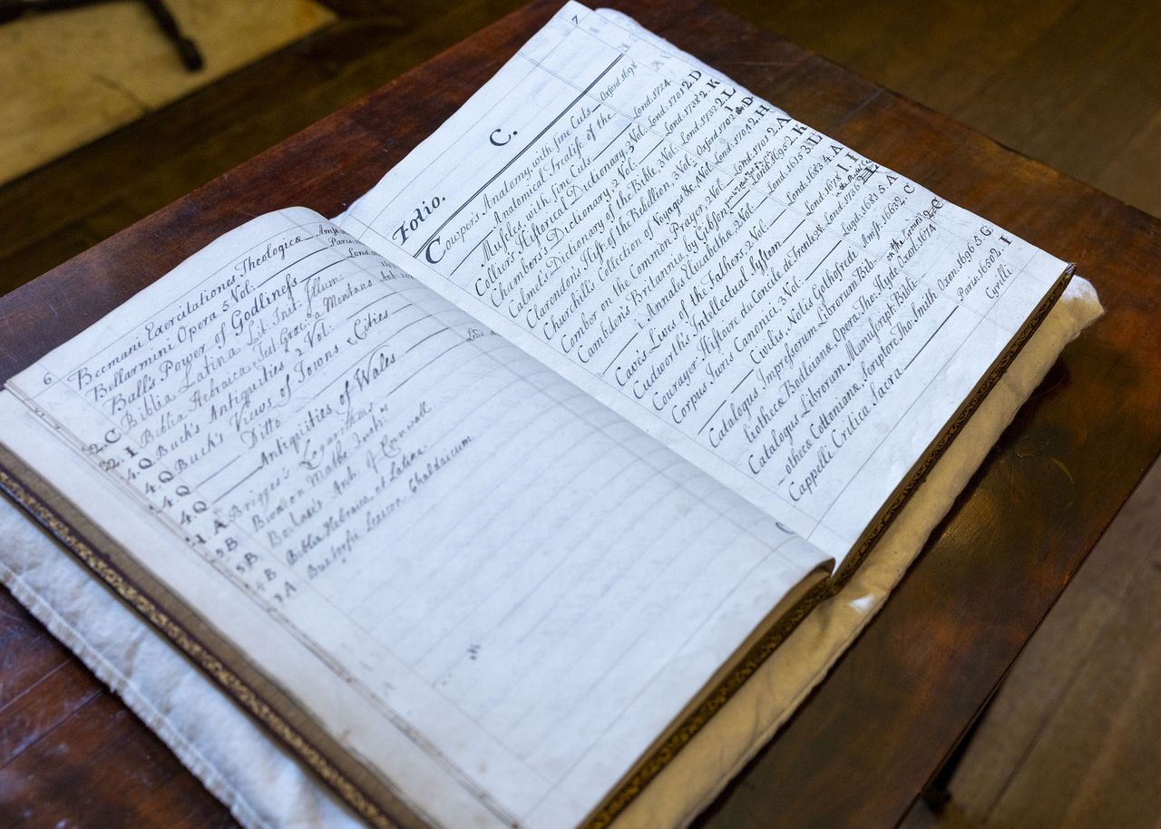 Charlie Courtenay, 19th Earl of Devon with his ancestor's book at Powderham Castle.