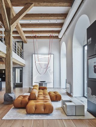 The showroom's ground floor with the Camaleonda modular sofa by Mario Bellini in caramel coloured leather and fabric