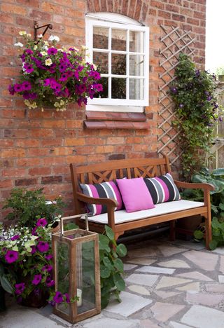 front garden with bench and hanging baskets