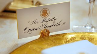 The place settings for Queen Elizabeth II sit ready in advance of the state dinner in her honor in the State Dining room