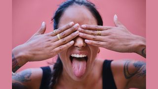 Woman with hands in front of face