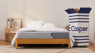 The Casper mattress on a bed, with its box next to it
