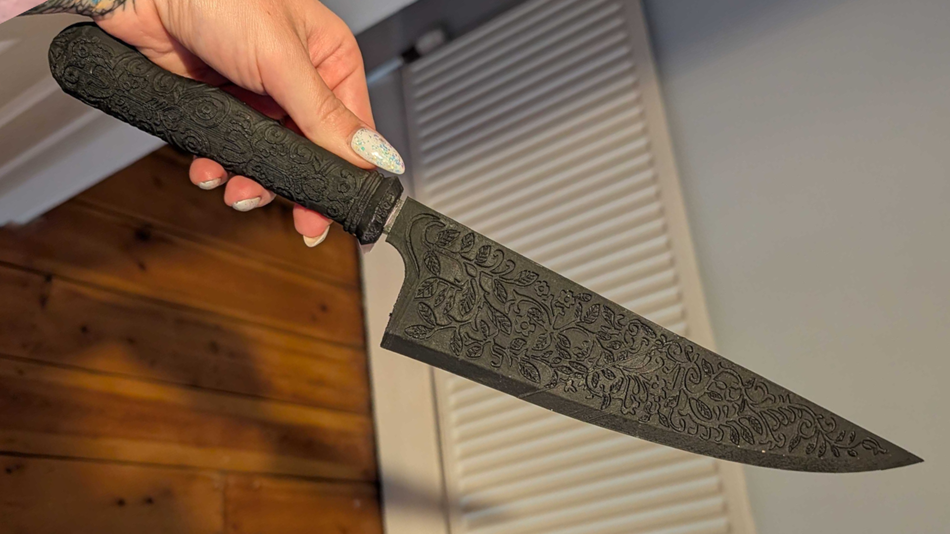 A hand holding a Vorpal Blade that's been 3D printed
