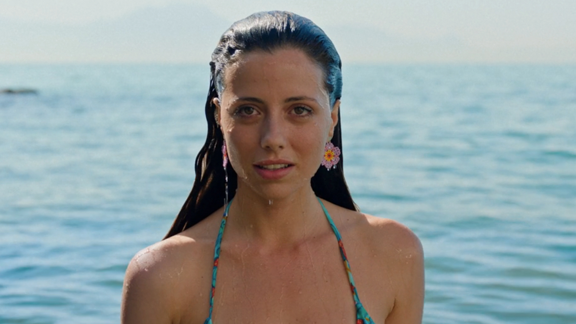 A woman with slicked back wet hair in Parthenope
