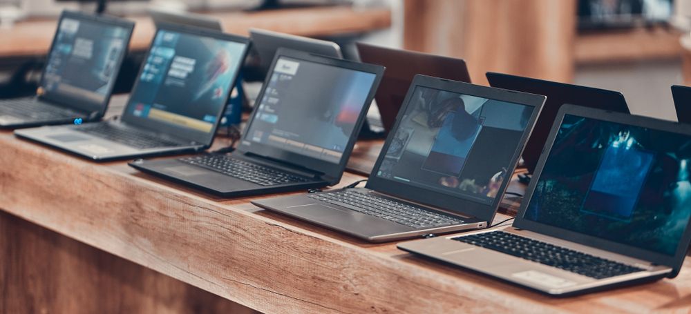 A row of laptops on a counter