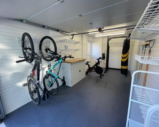 A garage home gym with white panelling