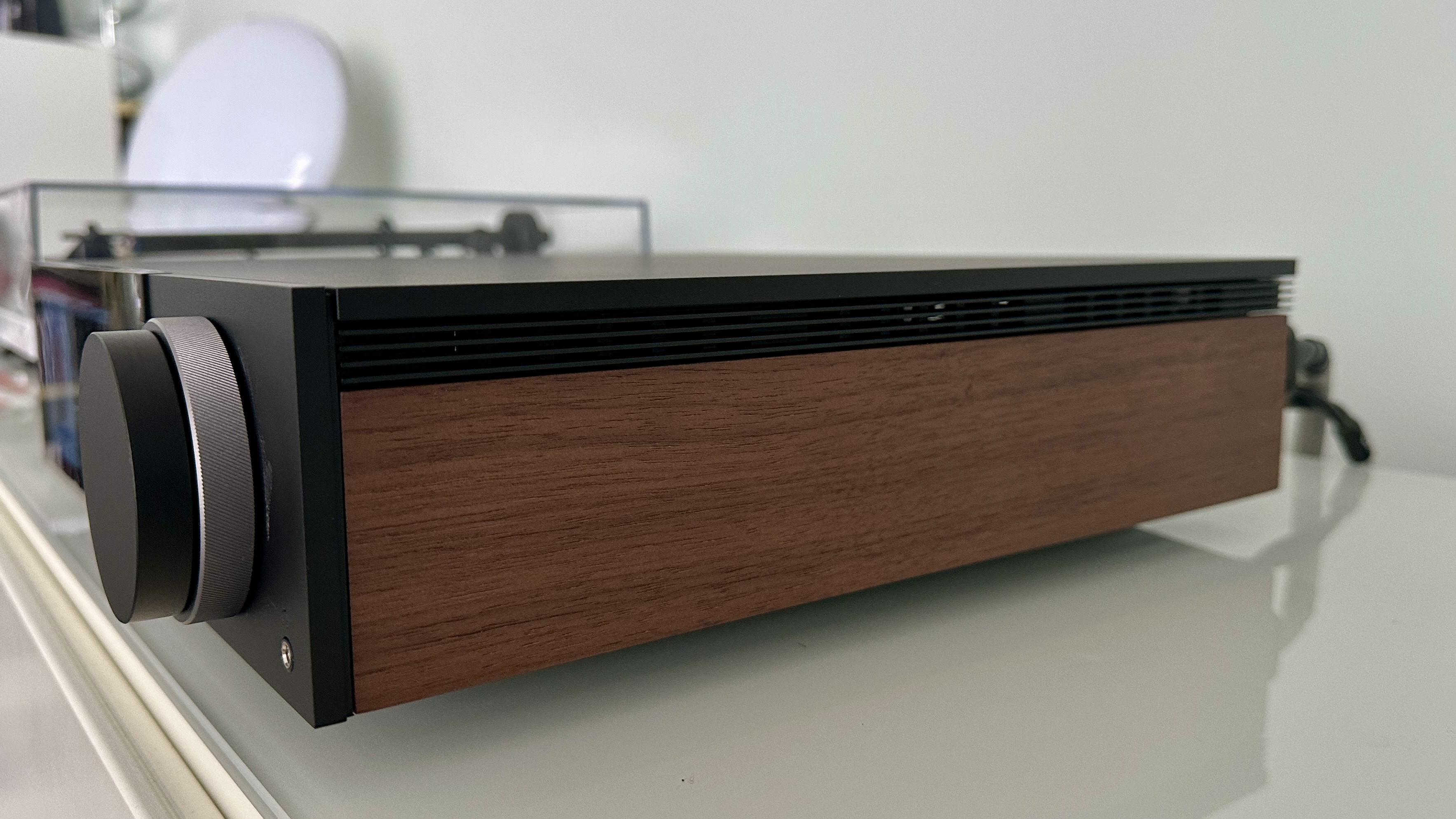 The Cambridge Evo 150 SE on a gray hi-fi rack, showing the color screen, grilles and ports