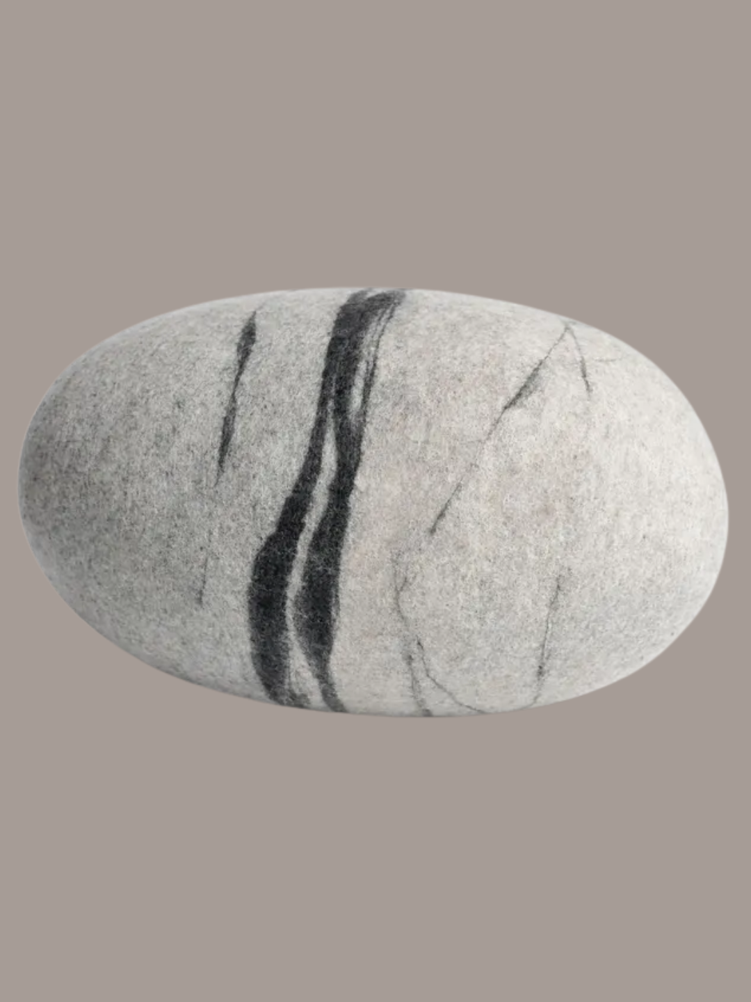 A felted wool stone pillow from Sandal Felt on Etsy