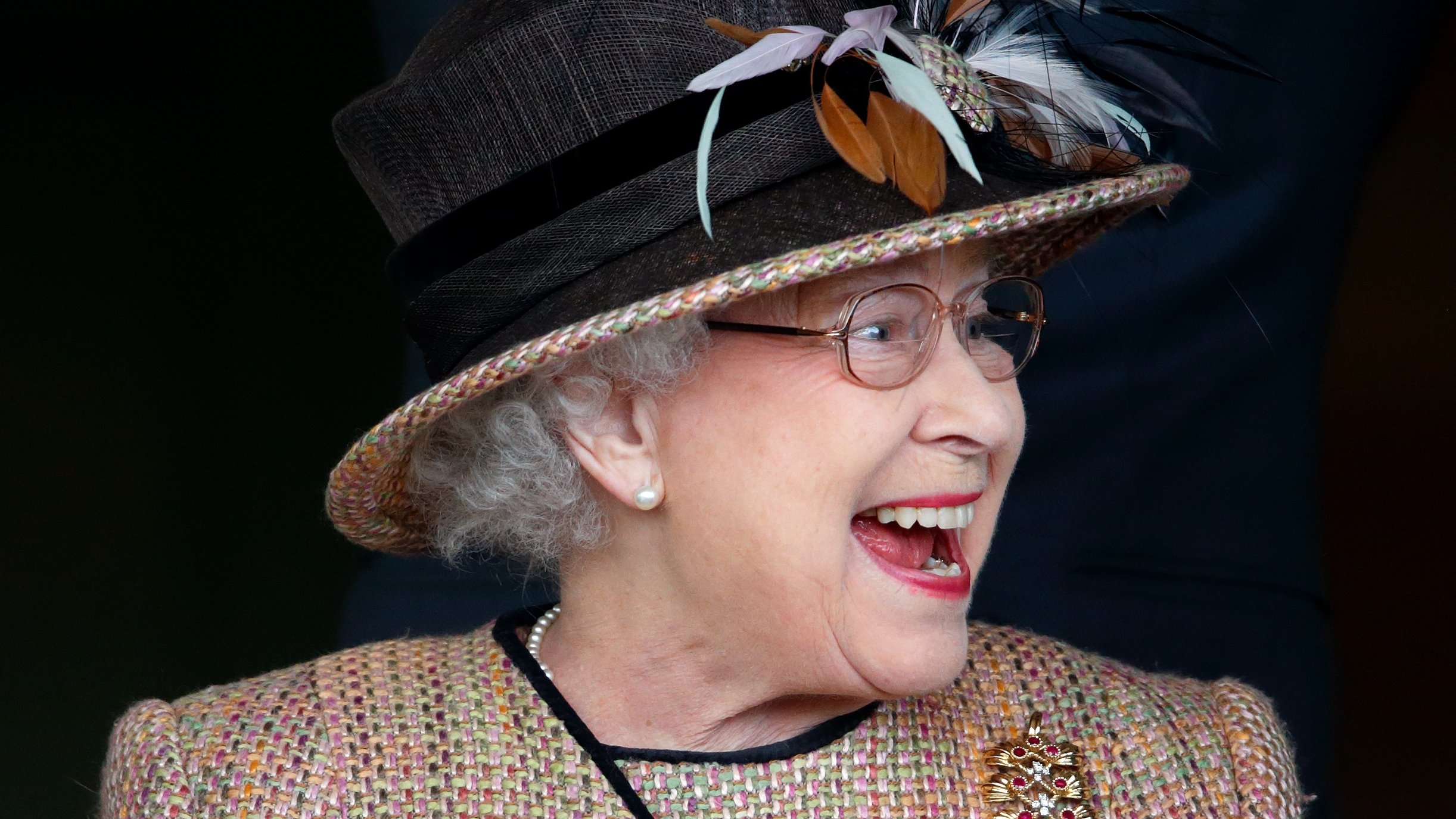 The Queen pranked - Queen Elizabeth II (wearing her gold and ruby floral trellis brooch) watches her horse 'Sign Manual' run in and win the Dreweatts Handicap Stakes as she attends the Dubai Duty Free Raceday at Newbury Racecourse on April 19, 2013 in Newbury, England.