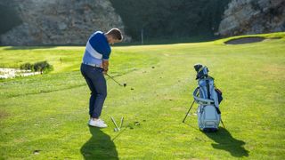 PGA pro Alex Elliott hitting a pitch shot at Infinitum Golf Resort in Spain