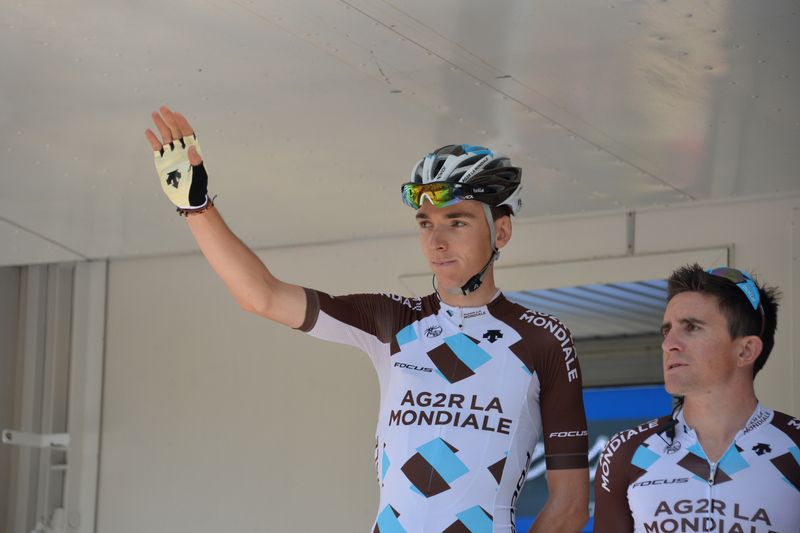 Romain Bardet waves from the stage