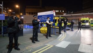 Police officers join staff from the Royal Liverpool University Hospital in a national round of applause for the NHS on Thursday