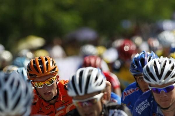 A rider reaches for his back pocket during the stage.