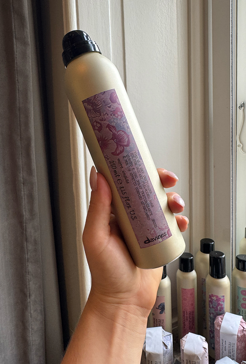 Rebecca holding Davines texturising spray