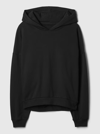A black hoodie from Gap on a plain backdrop