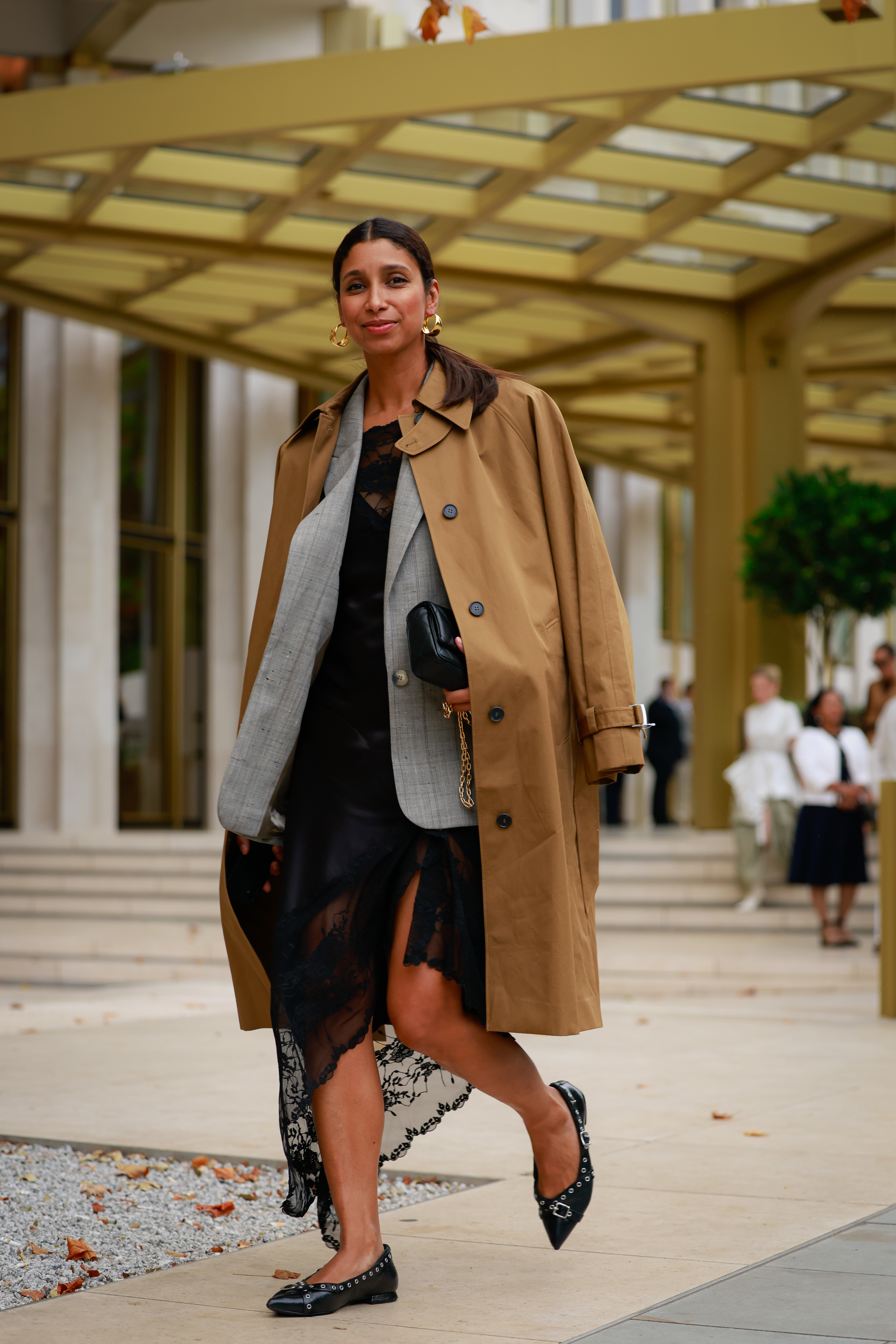 a woman wearing a jacket and flats during london fashion week