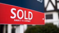 close up shot of sold sign outside house