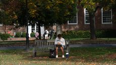 A student sits on the campus of Dartmouth College in Hanover, New Hampshire.