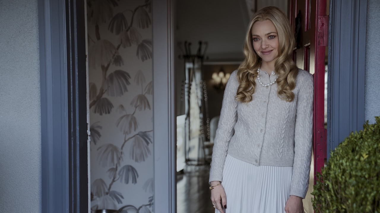 Amanda Seyfried smiling in a doorway in The Housemaid