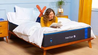 Nectar Memory Foam Mattress on a grey fabric bed base placed against a bright yellow wall