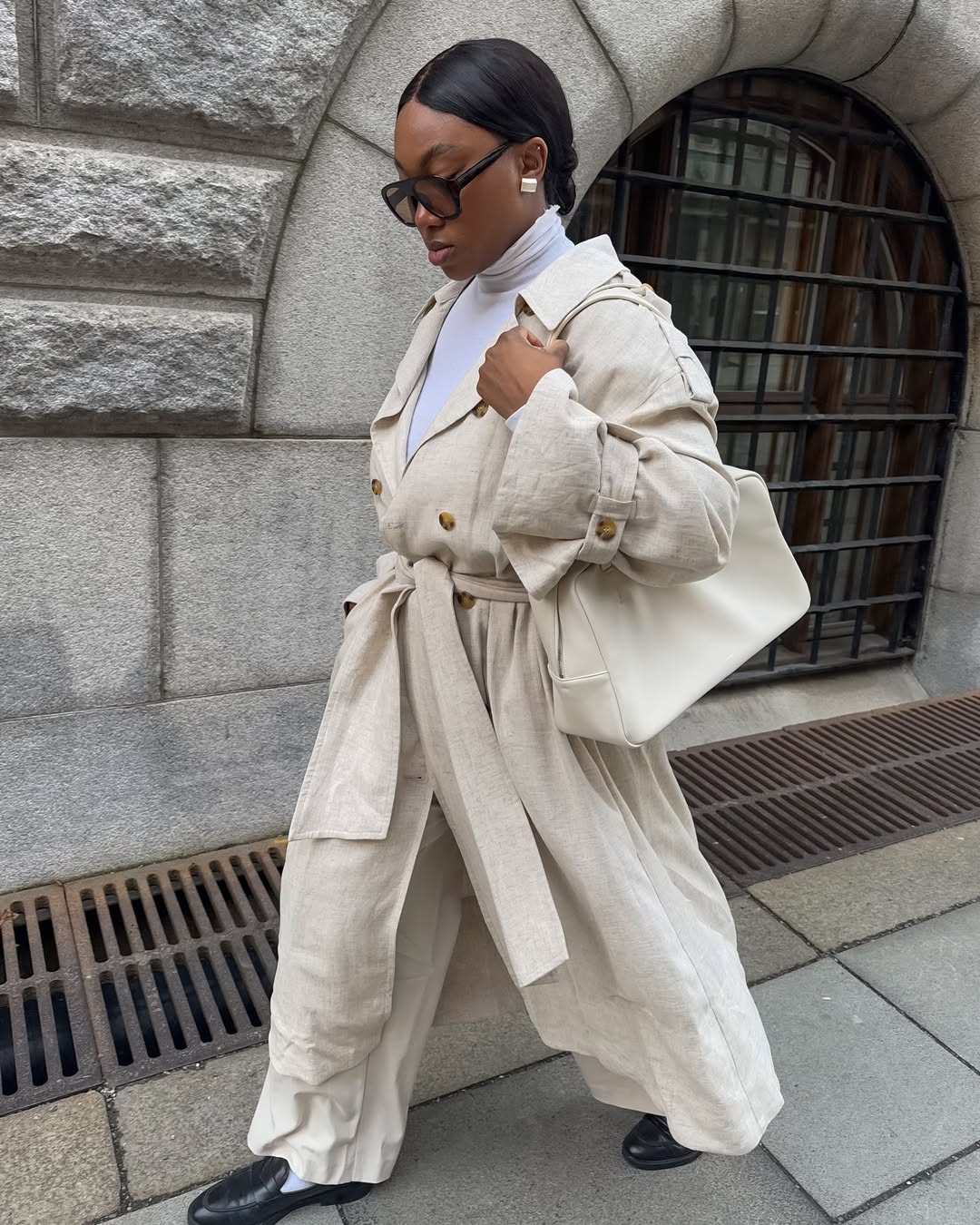 Nnenna in white trousers and black loafers