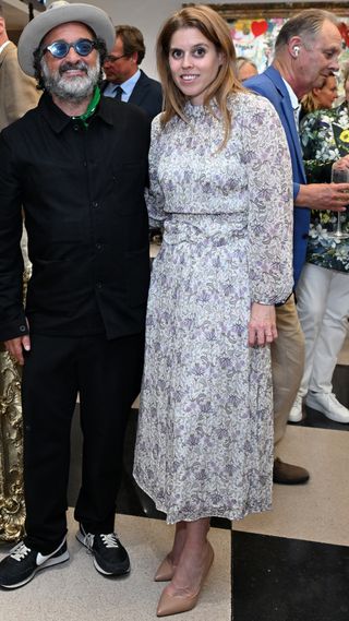 Mr. Brainwash and Princess Beatrice, wearing a floral dress, attend the presentation of Mr. Brainwash by Clarendon Fine Art and Jack Barclay Bentley