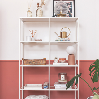 Pink and red drench walls and shelf