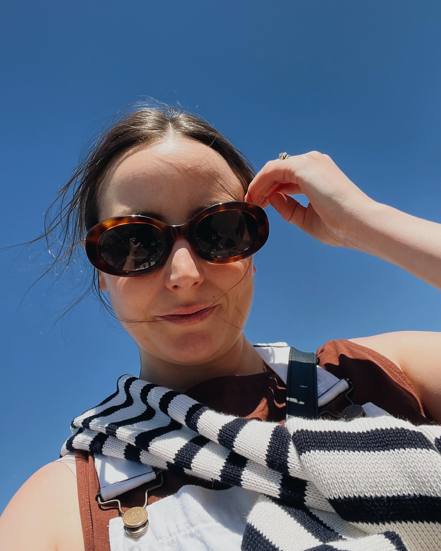 editor wears celine sunglasses with white line trouser outfit for summer